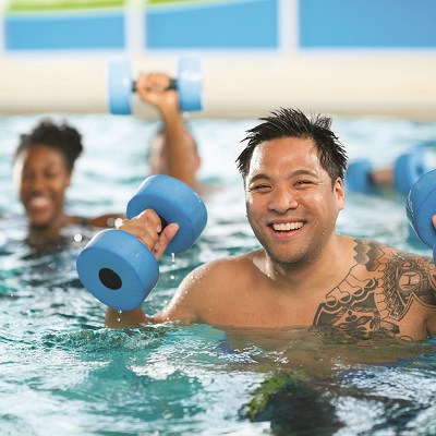 A man participating in YMCA shallow water extreme cardio fitness class