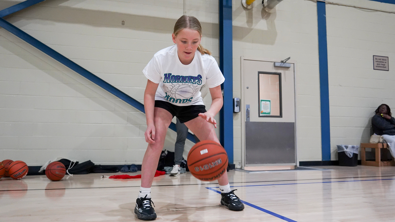 Edited photography of children enjoying The Charlotte Hornets' Hoop Clinic at our Harris center.