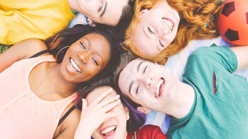 YouthPass Group of four friends laughing out loud outdoor, sharing good and positive mood.