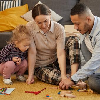 Family Activities Tile Full length portrait of happy modern family playing with cute little girl in cozy home interior, copy space